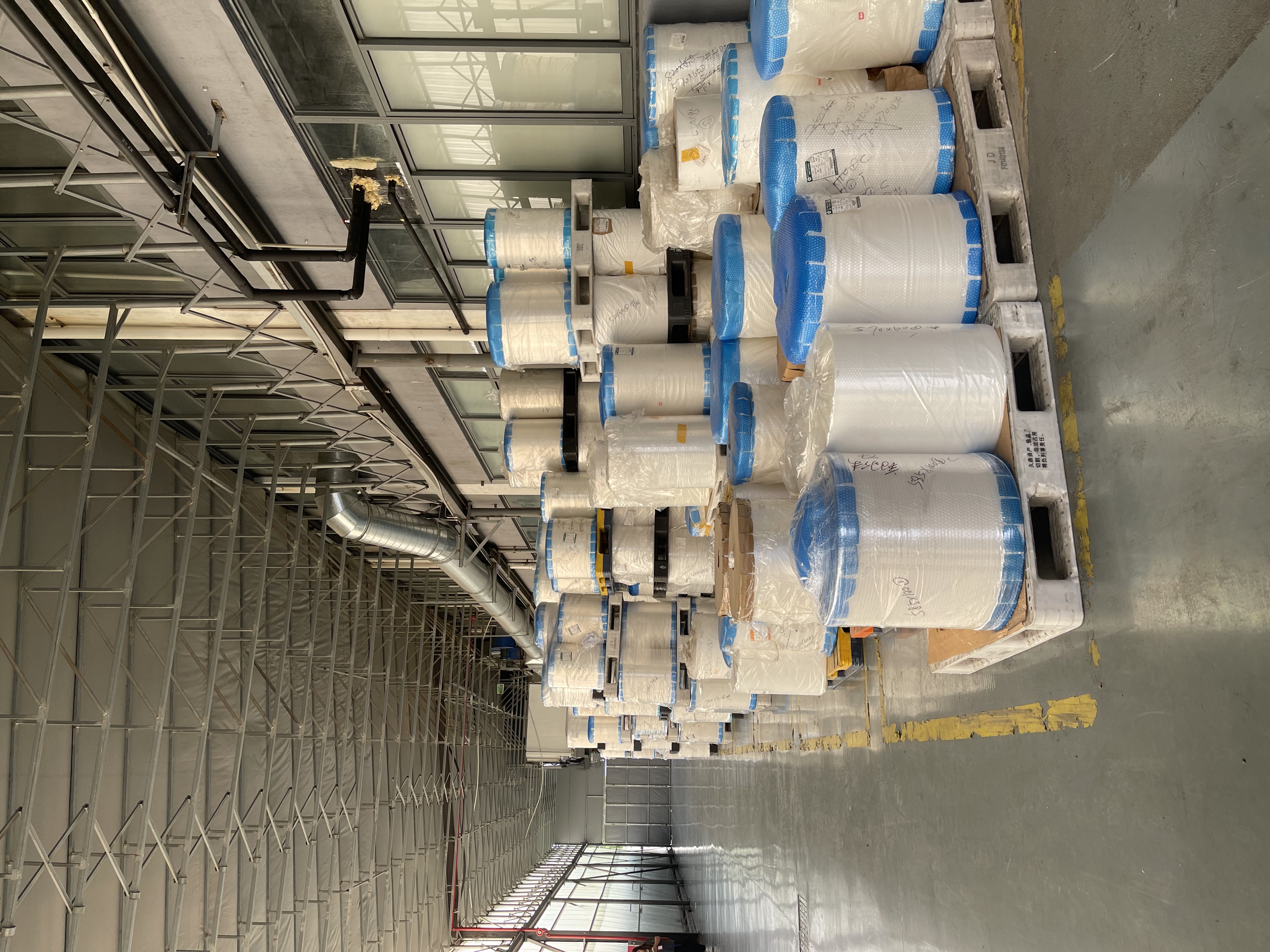 Raw material film roll warehouse Raw material film rolls stored at the BioPouches flexible packaging factory