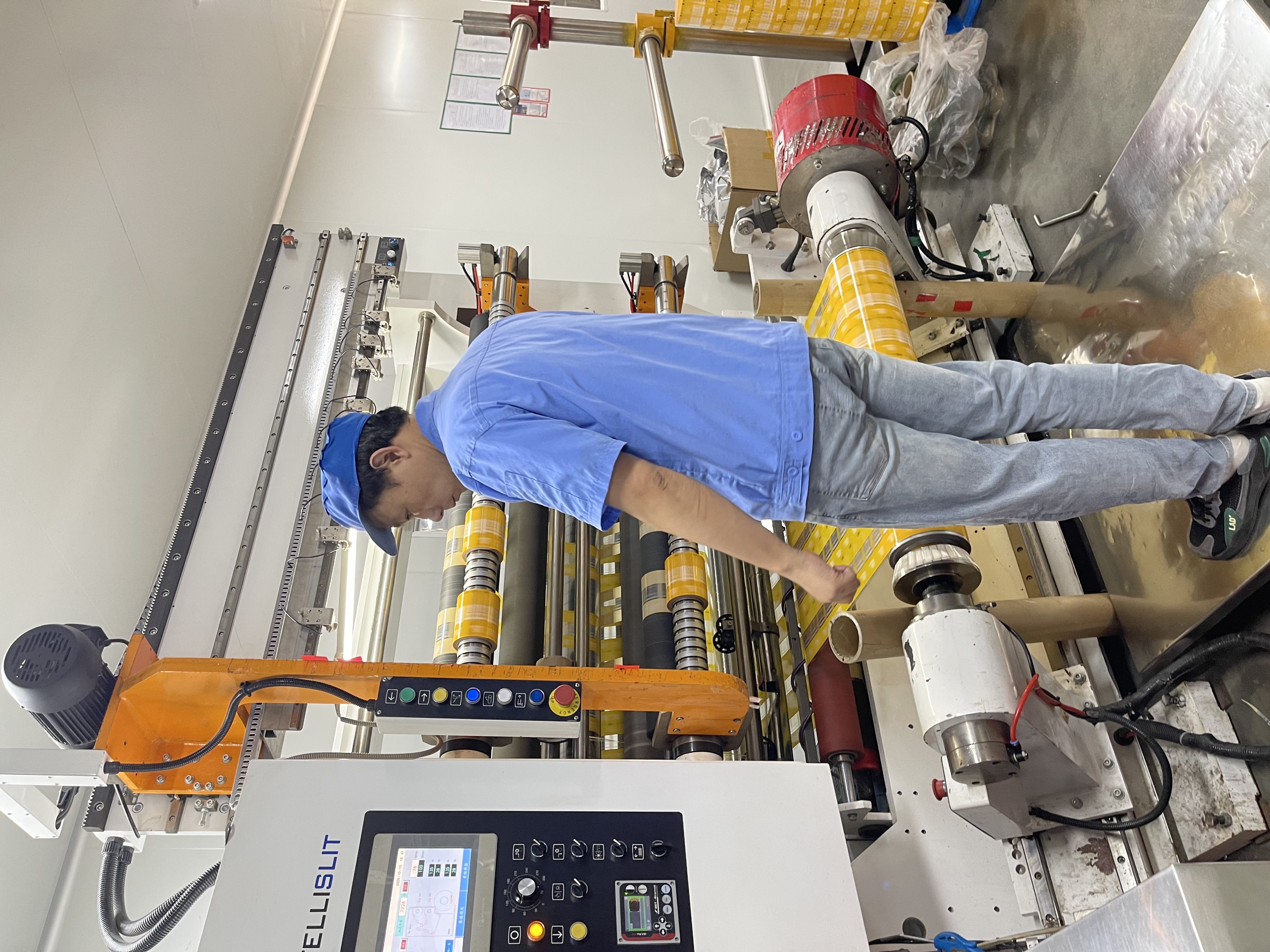 Cutting printed film Cutting printed flexible packaging film at the BioPouches factory
